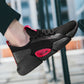 Black breathable knit running shoe with red logo patch and black laces