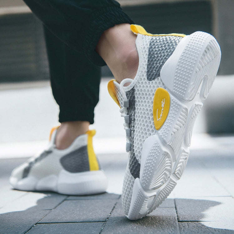 White mesh running shoe with gray side panel, yellow lace tag, and textured outsole