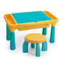 Kids building table with teal legs, yellow frame, and blue studded play surface