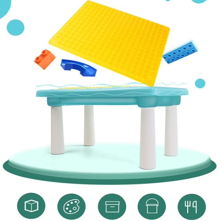 Yellow studded building board with scattered multicolor plastic blocks on a toy table