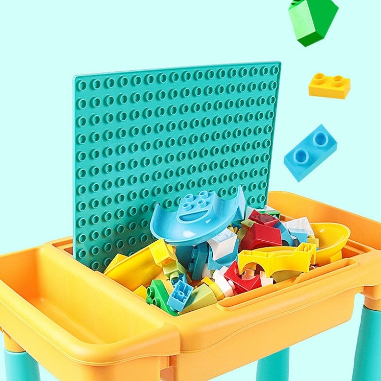 Children's building table toy with teal pegboard panel, yellow tray, and colorful blocks