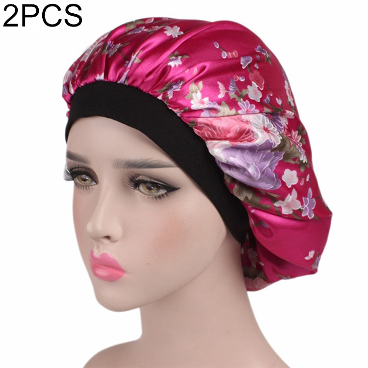 Women’s satin hair bonnet in magenta with floral print and black elastic band