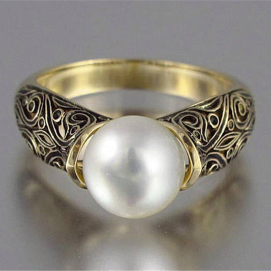 Gold-tone statement ring with round faux pearl center and filigree band