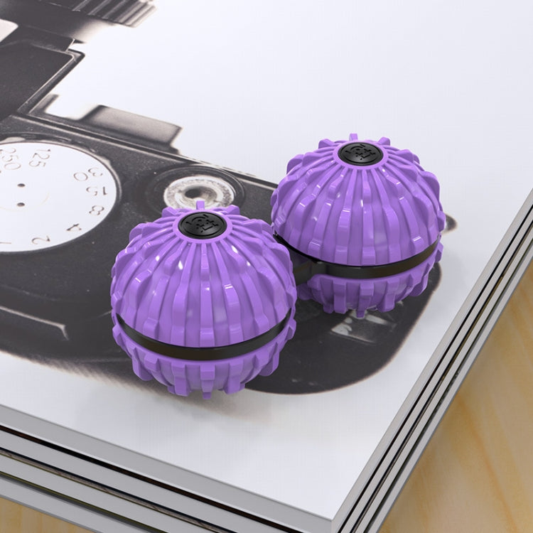 Two purple fingertip massage balls with black circular spin caps