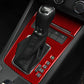 Red carbon-fiber gear shift panel trim with black boot and button cutouts