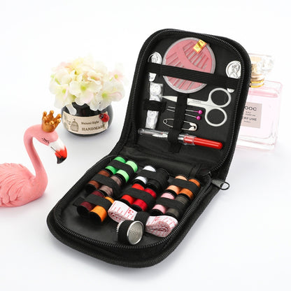 Black portable sewing kit case with thread, scissors, needles, and sewing accessories inside