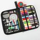 Open black sewing kit organizer with thread spools, pincushion, and assorted tools