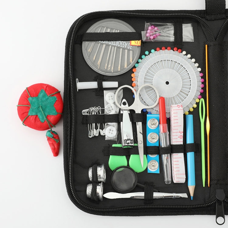 Open black sewing kit case with measuring tools, needles, scissors, and thread spools