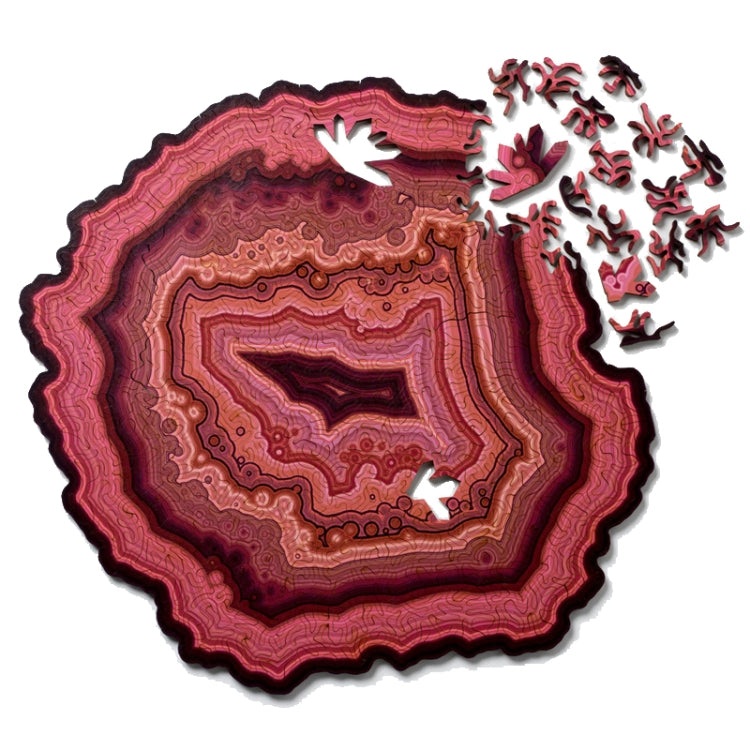Wooden jigsaw puzzle with red agate-style pattern and scattered puzzle pieces