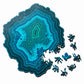 Wooden jigsaw puzzle with blue-green agate-style pattern and scattered puzzle pieces