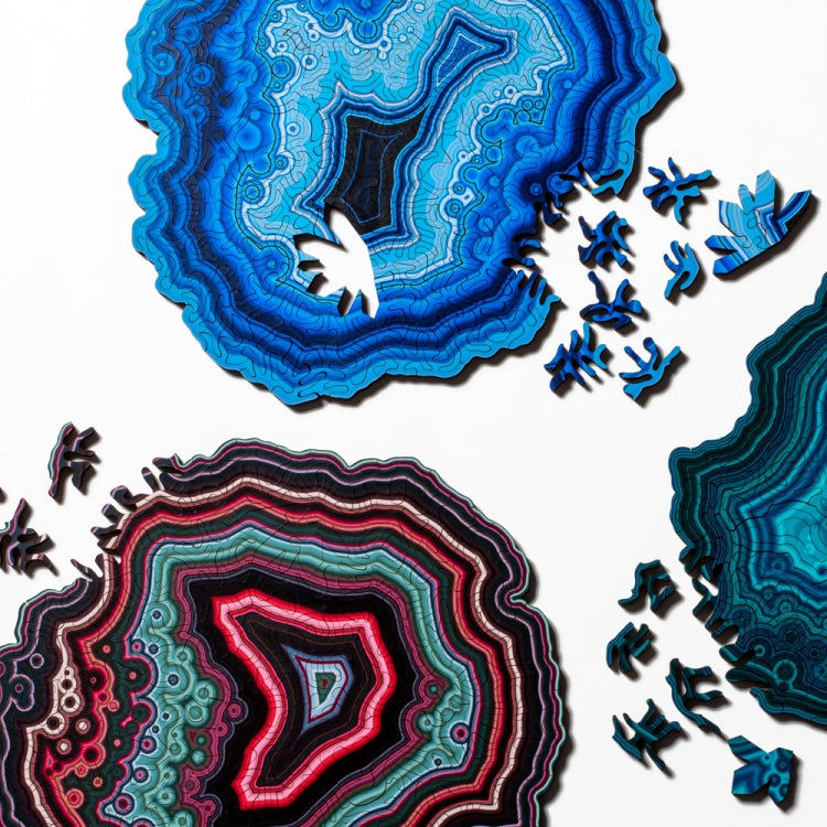 Wooden jigsaw puzzle with blue and multicolor agate patterns plus loose pieces