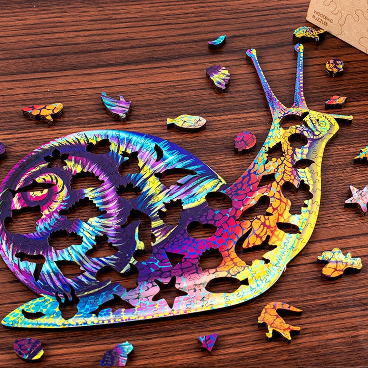 Rainbow wooden snail 3D puzzle on tabletop with small pieces scattered