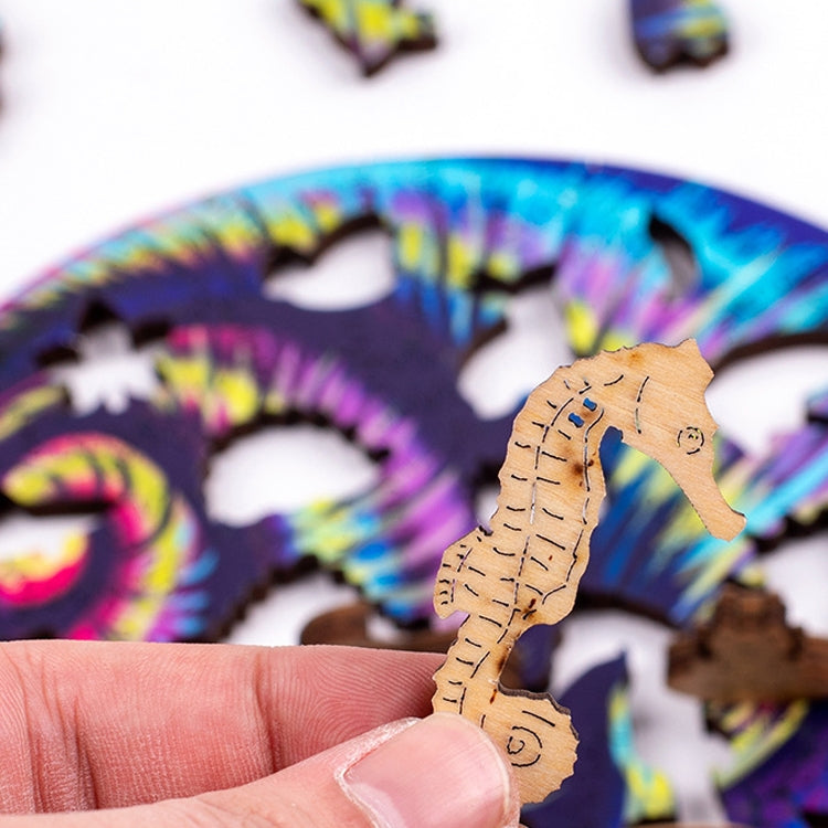 Hand holding a small wooden snail-shaped puzzle piece