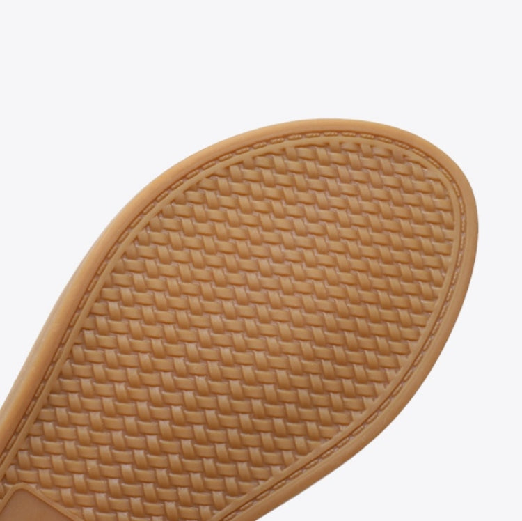Tan sandal sole with textured braided pattern and rounded toe edge