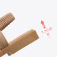 Tan flat sandal with ruched strap and ridged outsole, heel-to-toe view