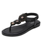 Black flat thong sandals with textured beadwork and elastic-look strap upper