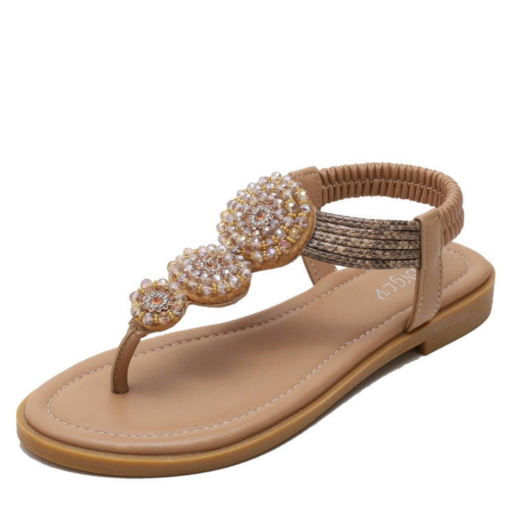 Tan flat sandals with beaded flower toe strap and textured side straps