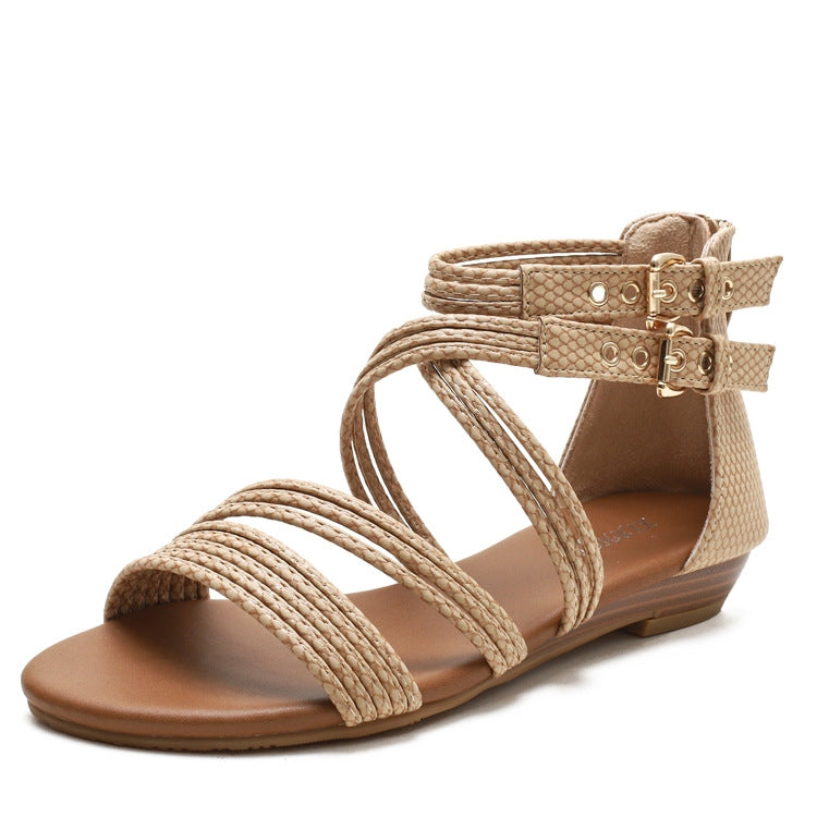 Apricot open-toe wedge sandals with crisscross straps and buckle ankle closure