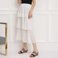 Gray strap platform wedge slide sandals on model with a white tiered dress
