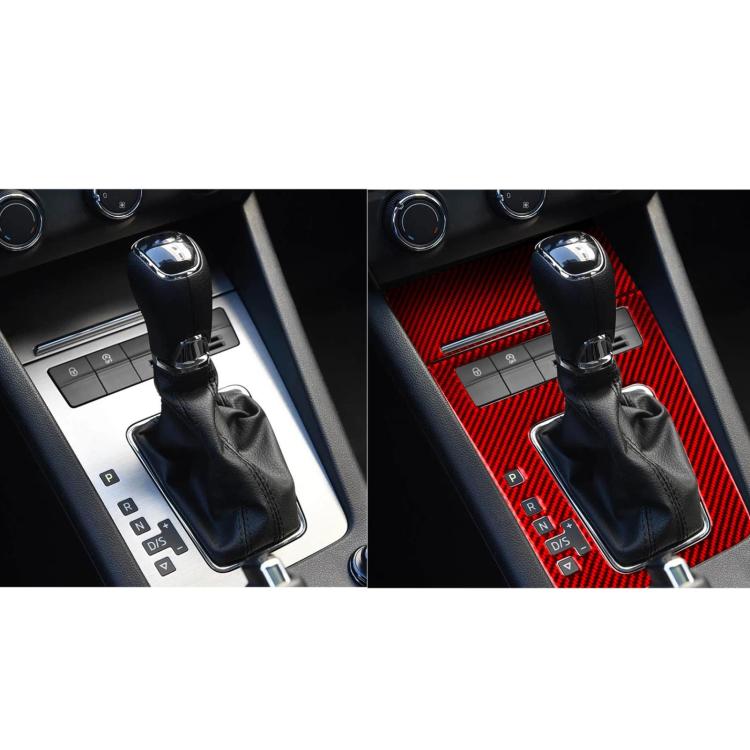Red carbon-fiber gear shift panel trim with black shift boot and surrounding console area.