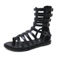 Black open-toe gladiator sandals with crisscross straps and multiple buckles at ankle
