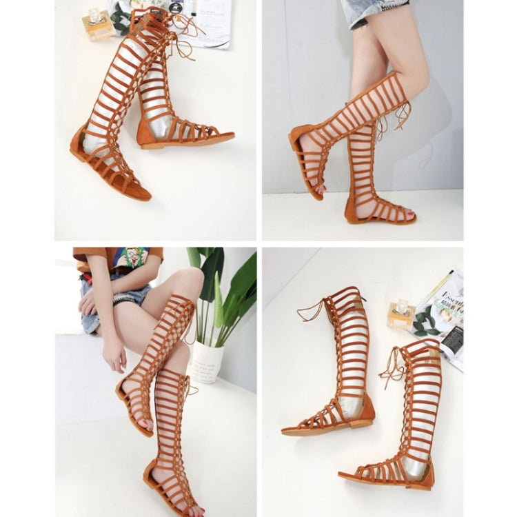Pair of brown high-top Roman sandals with striped cutouts and lace-up ankle