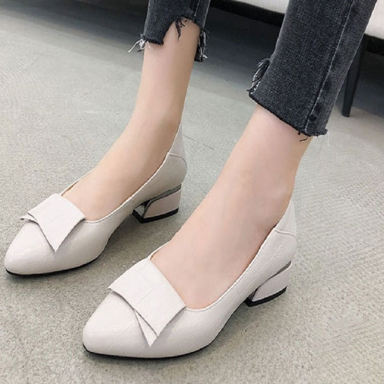 Women’s beige cowhide pumps with mid block heel, pointed toe, slip-on design
