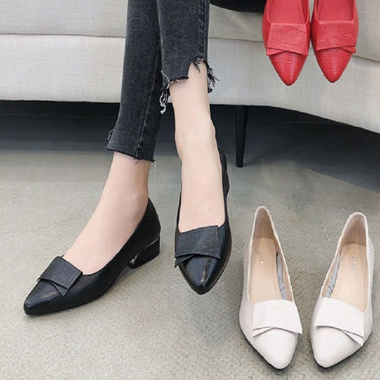 Women’s black and beige cowhide pointed pumps with mid block heels and strap design