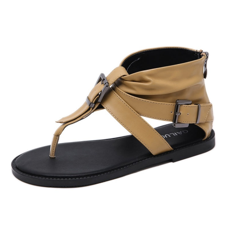 Light brown thong sandals with front X strap and metal buckle closure on black sole