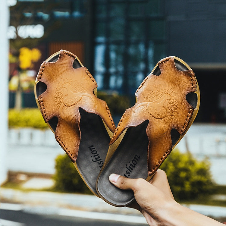 Orange leather slide sandals with cut-out upper and gray insole lining, pair view
