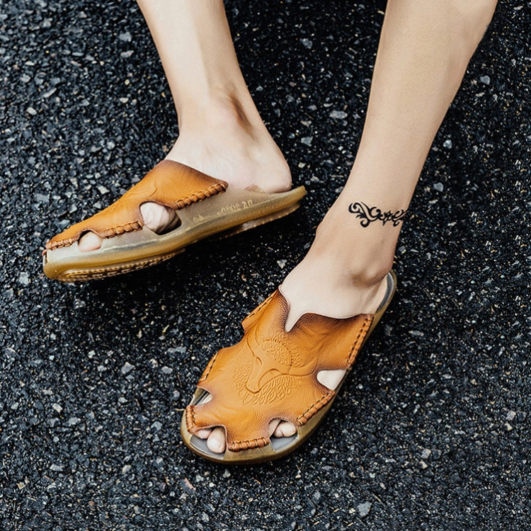 Men's leather sandals with open-toe cut-outs and flat sole, worn on pavement
