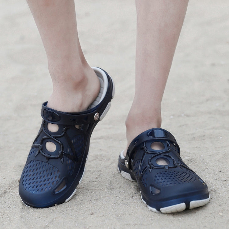 Dark blue clogs with perforated upper, strap detail, and white tread sole