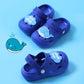 Children's blue clogs with cartoon face details and perforated footbed