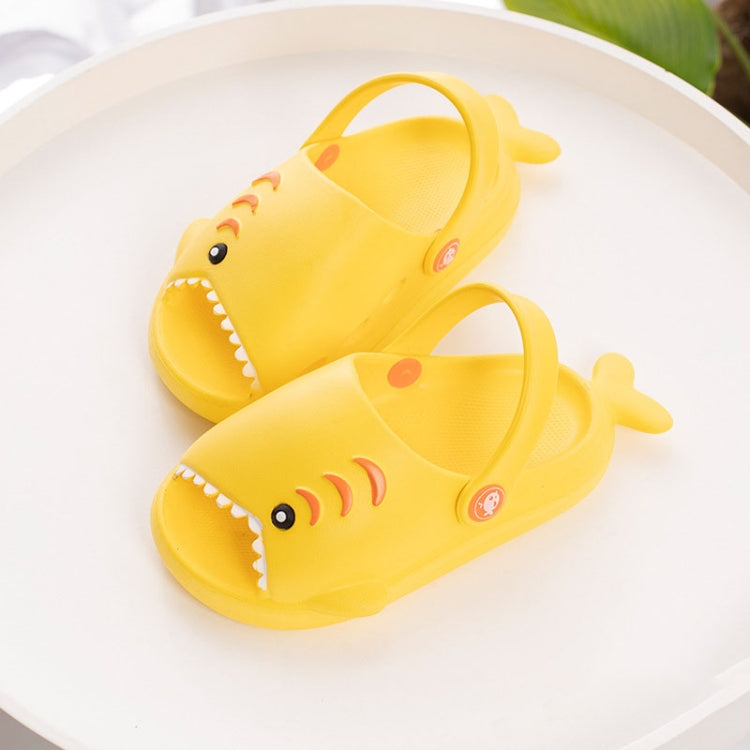 Yellow EVA shark slippers for kids, front view showing eye and smile graphics