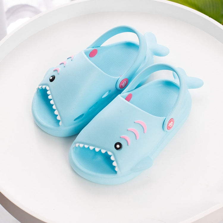 Light blue EVA shark slippers for children, showing eye, smile teeth, and wave stripes