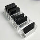 Transparent acrylic organizer with angled compartments for black lipstick tubes