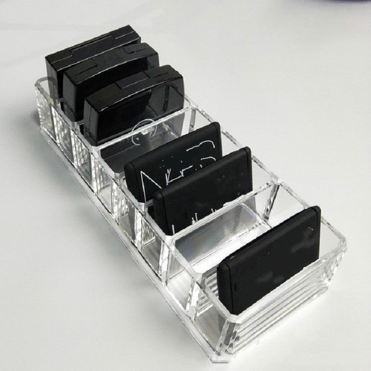 Transparent acrylic organizer with angled compartments for black lipstick tubes
