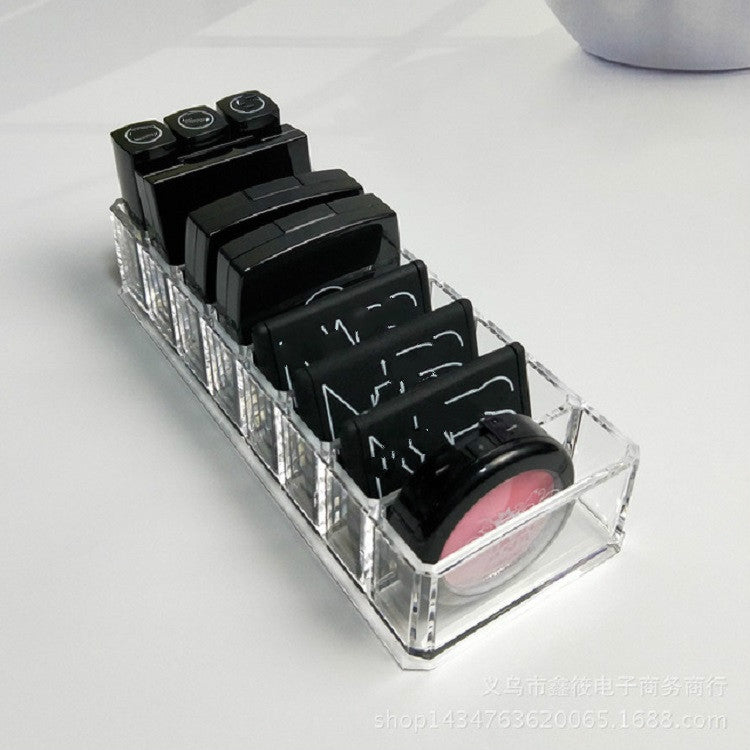 Clear acrylic makeup organizer with divided slots for lipsticks and pink shade