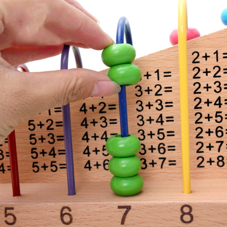 Hand placing green beads on a wooden math frame with equation rows