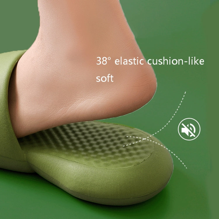 Green plastic slide slipper with textured footbed and cushioned sole, foot close-up
