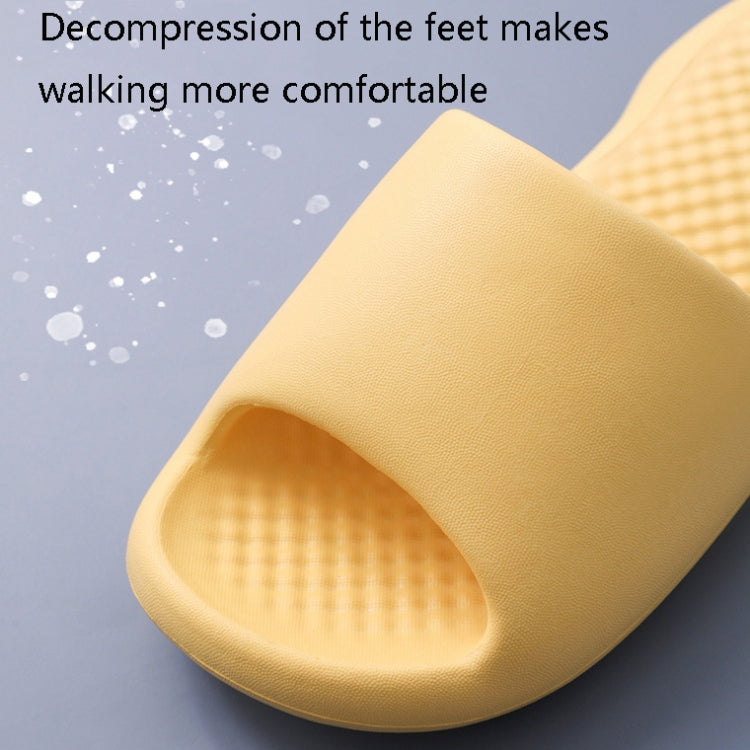 Yellow plastic slide slipper with textured underside and open-toe slide sole