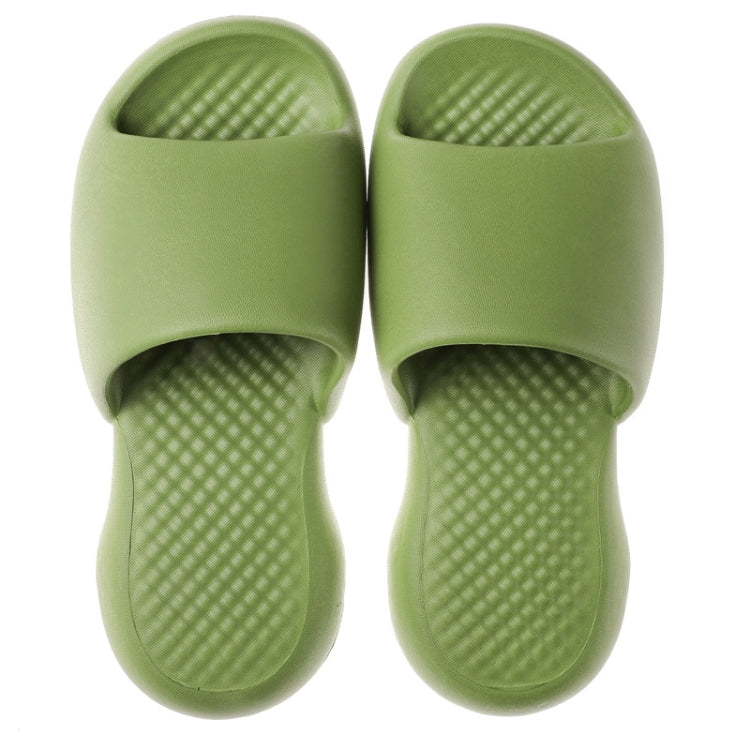 Pair of green plastic open-toe slippers with textured, grippy cushioning