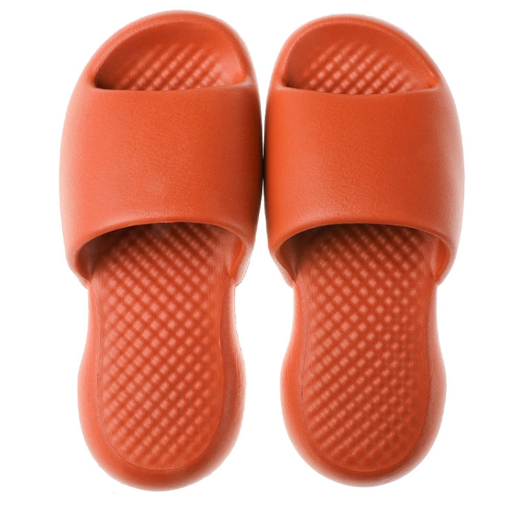 Orange plastic slide slippers with textured footbed and wide open toe, pair view