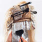 Hair dye brush with combs placed on wrapped hair during application