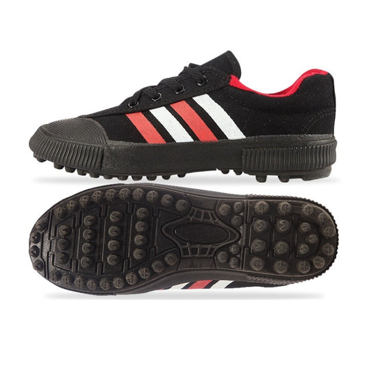 Black soccer training shoes with red-and-white striped upper and rubber spiked tread