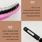 Hair brush comb close-up with pink head and rows of rounded bristles on textured handle