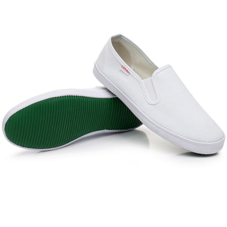 Unisex white slip-on sneakers showing green underside and beige inner lining