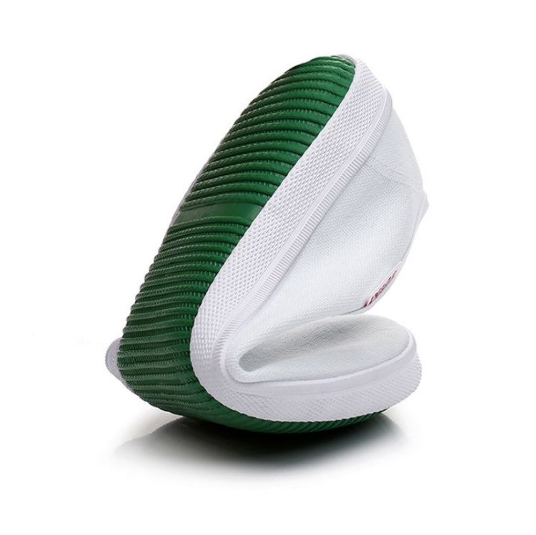 Low-top canvas sneakers with green ribbed side panel and white rubber sole