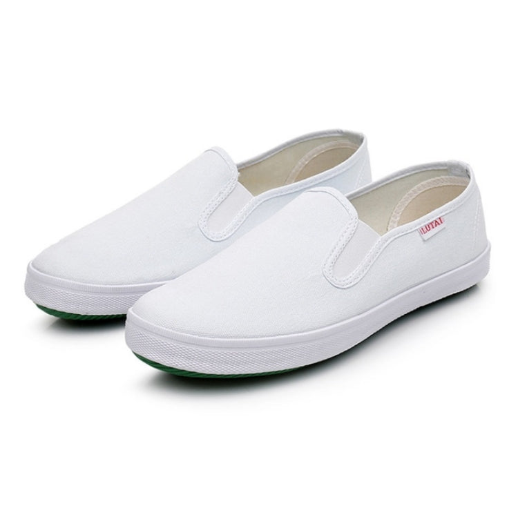 Unisex white canvas low-top slip-on sneakers with cushioned collar and green outsole