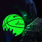 Fluorescent green reflective basketball glowing in a hand, near a seated person